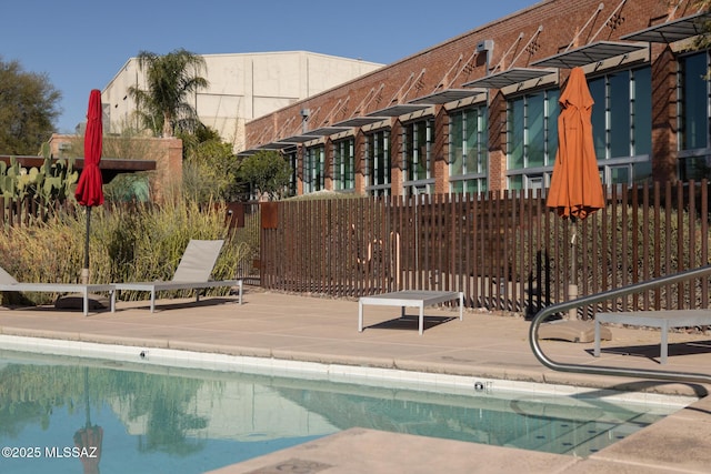 view of pool featuring fence