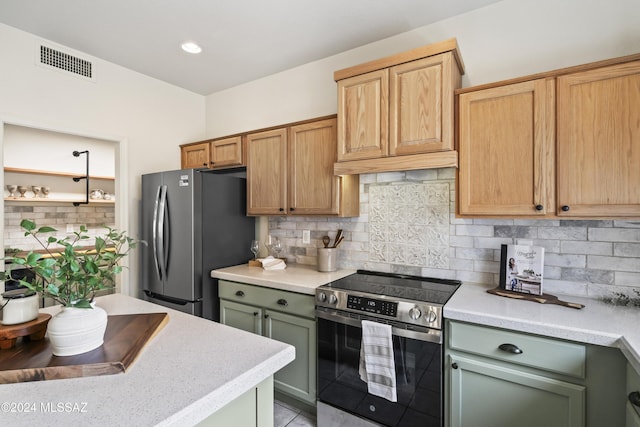 kitchen with visible vents, backsplash, appliances with stainless steel finishes, and light countertops