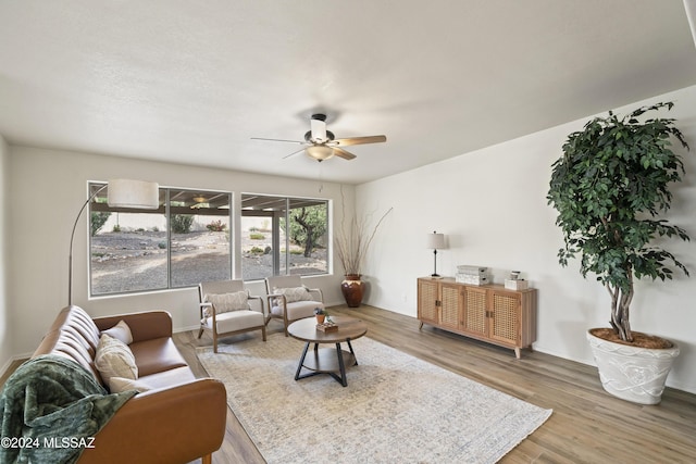 living area featuring wood finished floors and ceiling fan