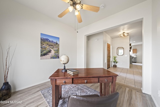 office with light wood-style flooring, baseboards, and ceiling fan