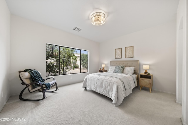 bedroom with light carpet, visible vents, and baseboards