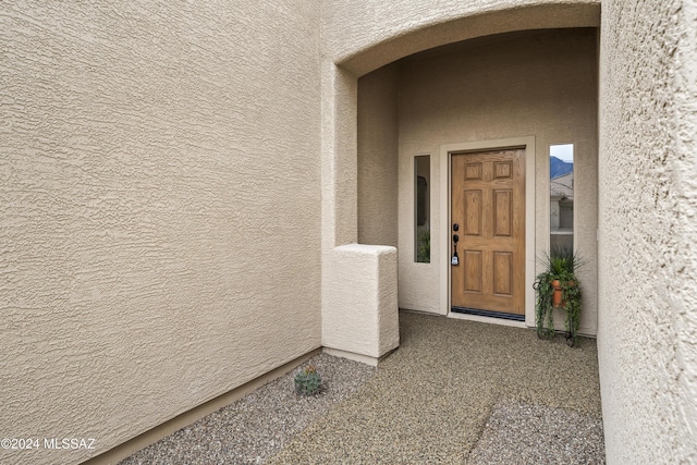 entrance to property featuring stucco siding