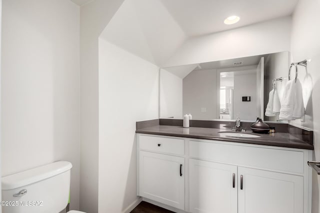 half bath with recessed lighting, visible vents, toilet, and vanity