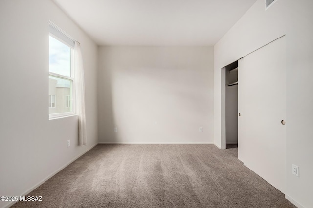 unfurnished bedroom with a closet and carpet flooring