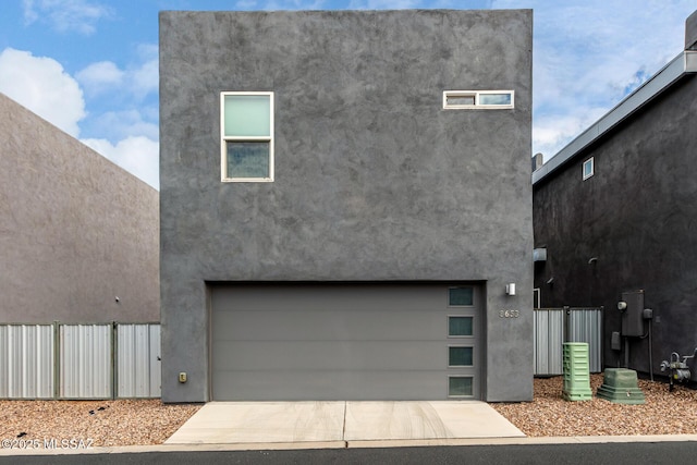 view of front of home featuring stucco siding, an attached garage, and driveway