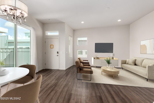 living area featuring recessed lighting, wood finished floors, a wealth of natural light, and a chandelier