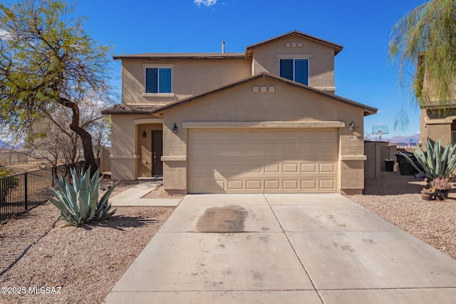 traditional home with stucco siding, concrete driveway, a garage, and fence