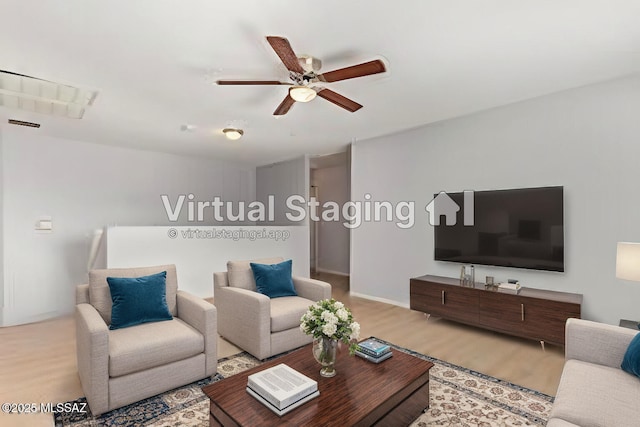 living area featuring wood finished floors and ceiling fan