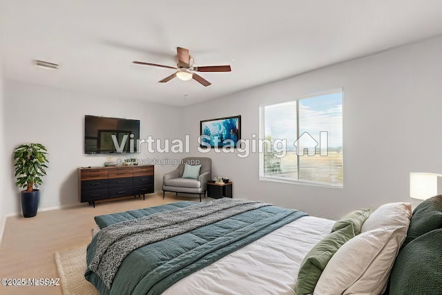 carpeted bedroom with a ceiling fan and visible vents