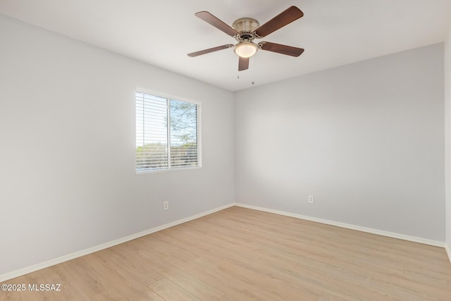 unfurnished room with baseboards, light wood-style floors, and a ceiling fan