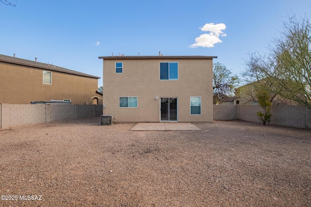 back of house featuring stucco siding, a patio, central AC unit, and a fenced backyard