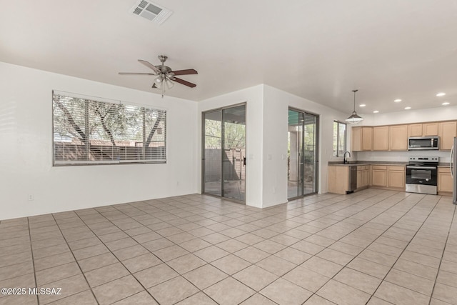 kitchen with visible vents, light brown cabinetry, open floor plan, recessed lighting, and stainless steel appliances