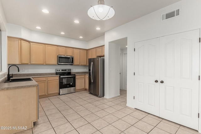 kitchen featuring visible vents, recessed lighting, light brown cabinetry, a sink, and appliances with stainless steel finishes