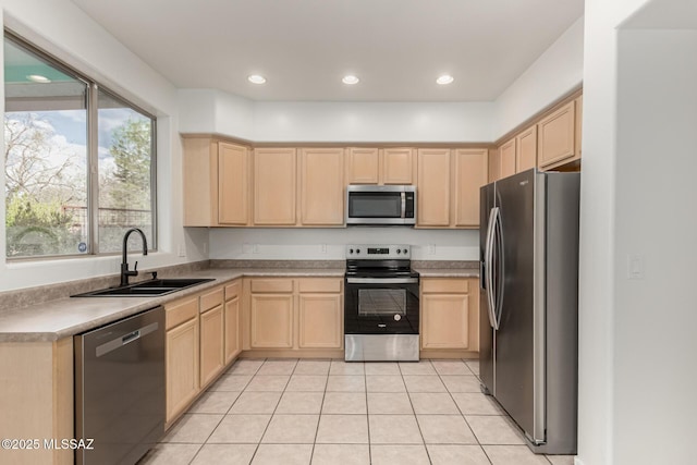 kitchen featuring a sink, appliances with stainless steel finishes, recessed lighting, and light brown cabinets