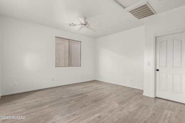 unfurnished room with visible vents, light wood-style flooring, baseboards, and ceiling fan