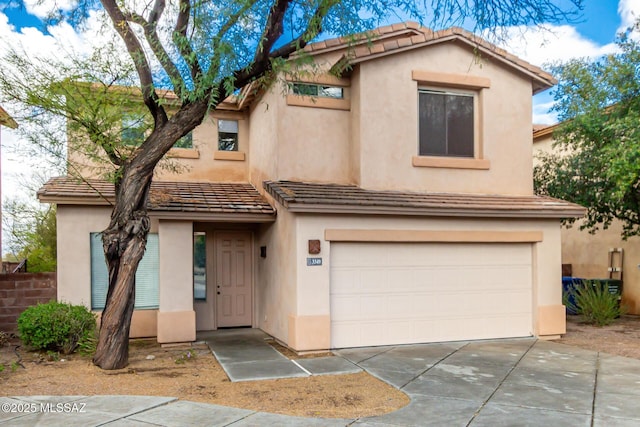 view of front of property with stucco siding, driveway, and an attached garage