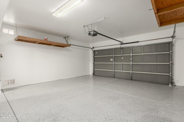 garage featuring visible vents and a garage door opener