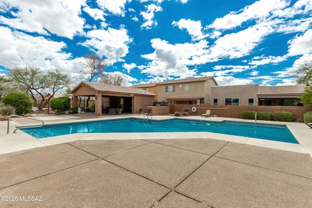 pool featuring a patio area and fence