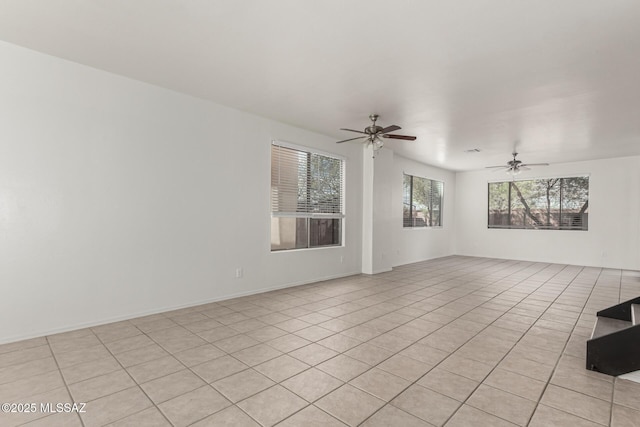 unfurnished room featuring baseboards and ceiling fan