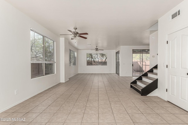 empty room featuring light tile patterned floors, visible vents, and a ceiling fan