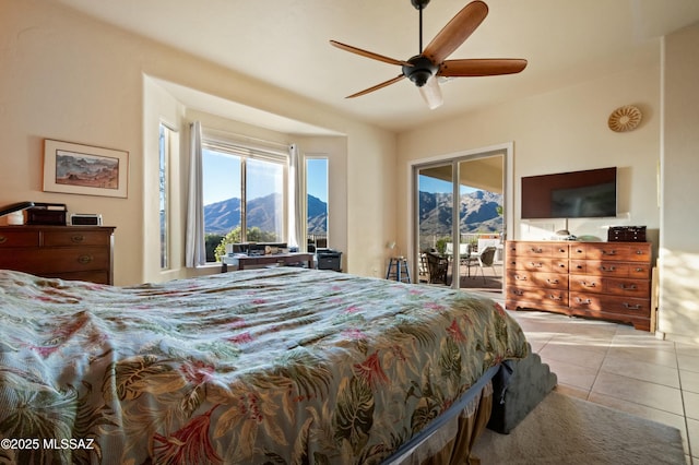 tiled bedroom with access to exterior and a ceiling fan