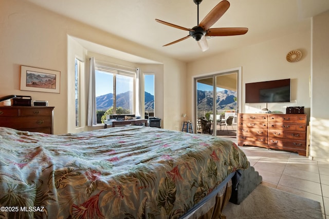 tiled bedroom featuring access to exterior and a ceiling fan