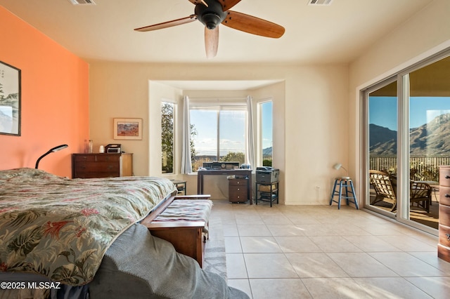 bedroom with tile patterned floors, visible vents, ceiling fan, a mountain view, and access to exterior