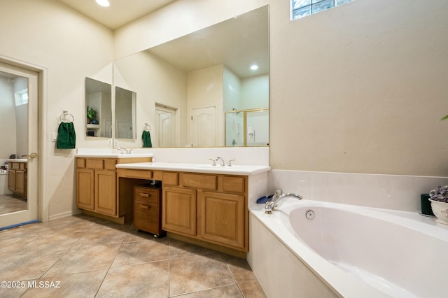 full bath with double vanity, a sink, tile patterned flooring, a shower stall, and a bath