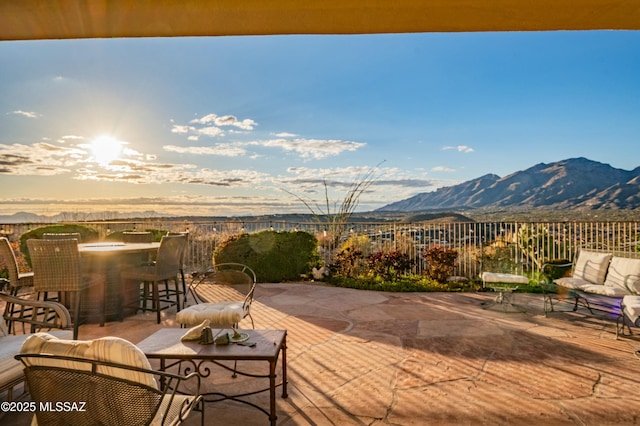 view of patio with an outdoor living space and a mountain view