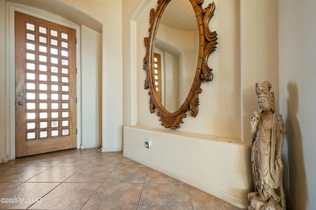 tiled foyer entrance featuring baseboards