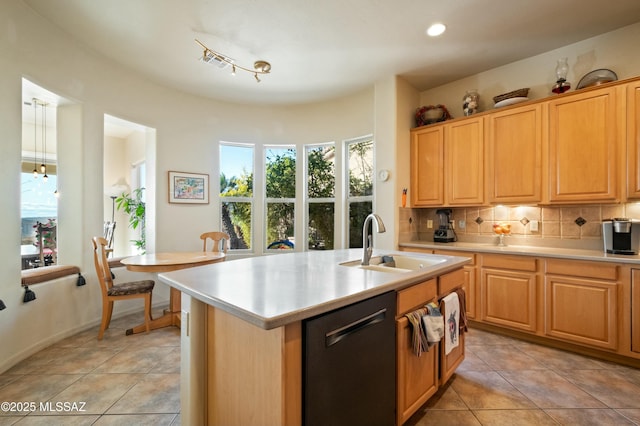 kitchen featuring dishwasher, light countertops, backsplash, and a sink
