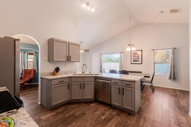 kitchen featuring visible vents, a sink, a peninsula, gray cabinetry, and stainless steel appliances