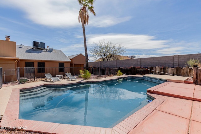 view of swimming pool with a patio, central AC, and a fenced backyard