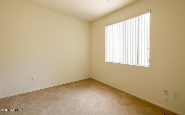 carpeted empty room with baseboards