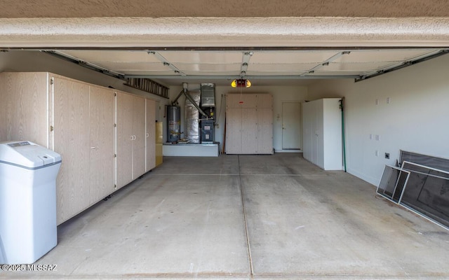 garage featuring heating unit, a garage door opener, and water heater