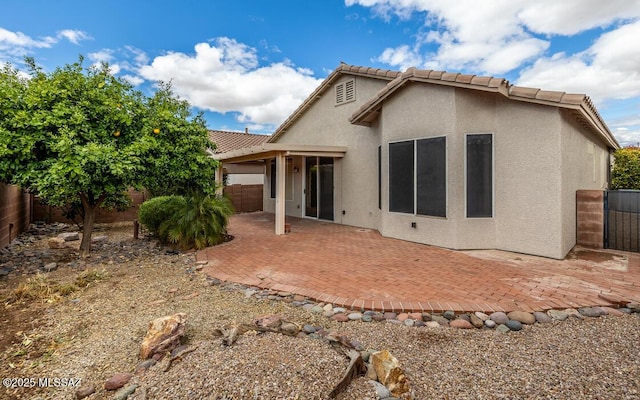 back of property featuring a patio, a tiled roof, a fenced backyard, and stucco siding