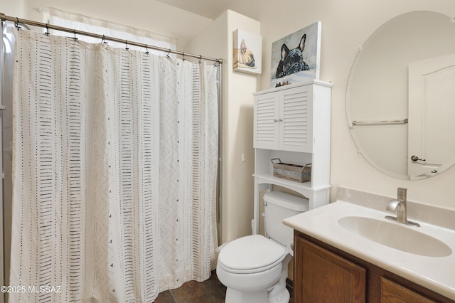 bathroom featuring curtained shower, toilet, and vanity