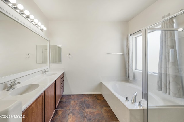 full bathroom with a sink, a garden tub, a stall shower, and double vanity