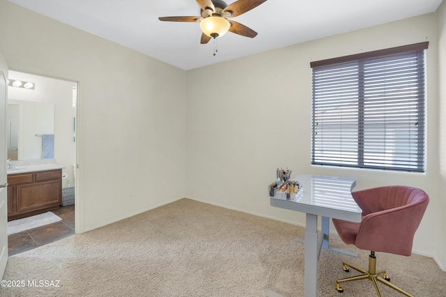 home office featuring carpet flooring, a ceiling fan, plenty of natural light, and a sink