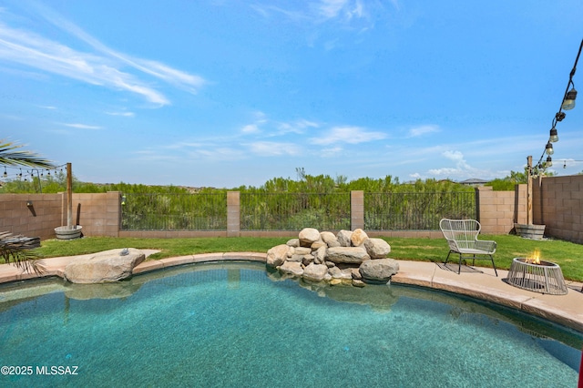 view of swimming pool with a patio area, a fenced in pool, an outdoor fire pit, and a fenced backyard