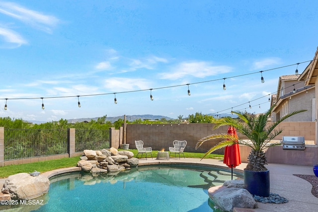 view of pool with a patio area, grilling area, and a fenced backyard