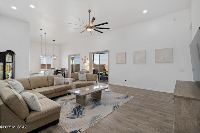 3337 E Wet Sand Pl, Vail, AZ 85641 - living area featuring a ceiling fan, wood finished floors, recessed lighting, a high ceiling, and baseboards