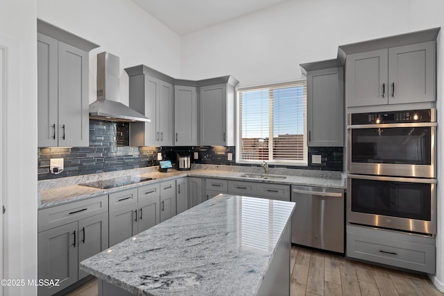 3337 E Wet Sand Pl, Vail, AZ 85641 - kitchen with wall chimney exhaust hood, stainless steel appliances, gray cabinets, a sink, and decorative backsplash