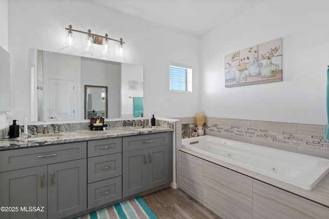 3337 E Wet Sand Pl, Vail, AZ 85641 - bathroom featuring a tub with jets, wood finished floors, and double vanity