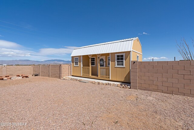 3337 E Wet Sand Pl, Vail, AZ 85641 - view of front of home featuring a fenced backyard, a mountain view, metal roof, and an outdoor structure