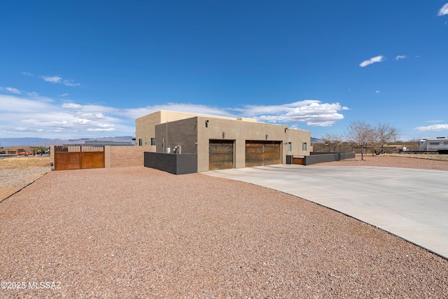 3337 E Wet Sand Pl, Vail, AZ 85641 - view of outbuilding with concrete driveway, a garage, fence, and a mountain view