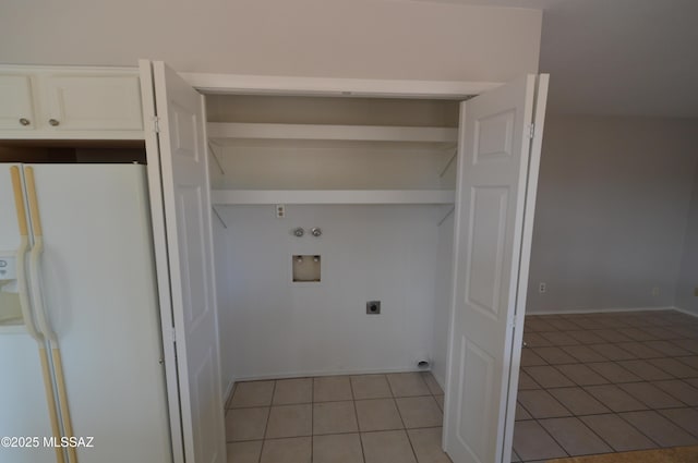 clothes washing area featuring hookup for an electric dryer, laundry area, light tile patterned floors, and hookup for a washing machine
