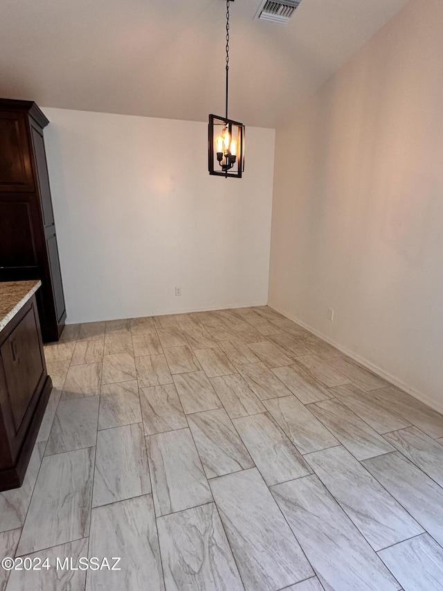 unfurnished dining area with visible vents and a chandelier