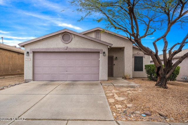 ranch-style house featuring stucco siding, an attached garage, and concrete driveway