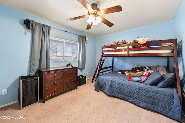 carpeted bedroom featuring ceiling fan and baseboards